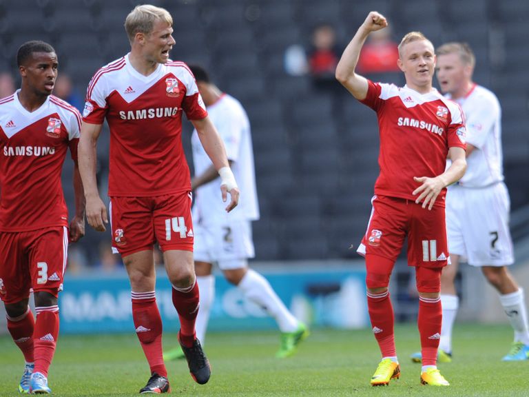 Alex Pritchard celebrates his free-kick strike for Swindon