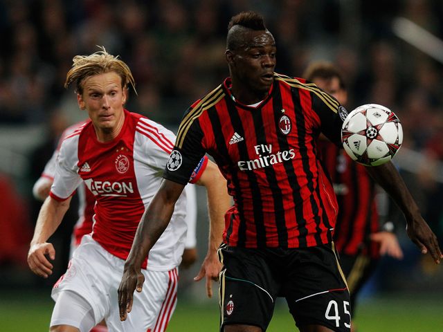 Mario Balotelli holds off Christian Poulsen