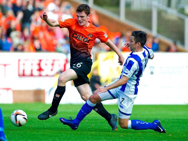Andrew Robertson receives a challenge from Barry Nicholson