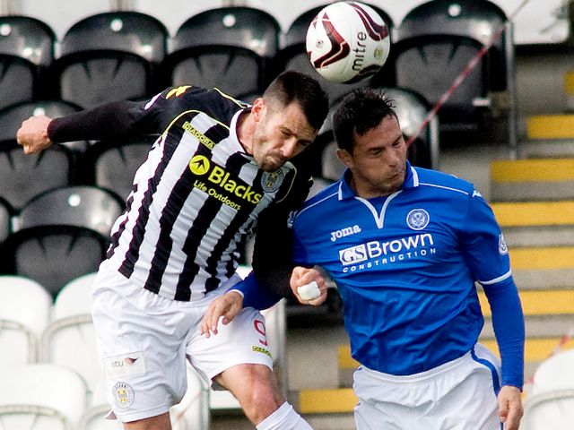 Steven Thompson and Gary Miller jump for the ball