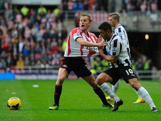 Hatem Ben Arfa tries to hold Sebastian Larsson