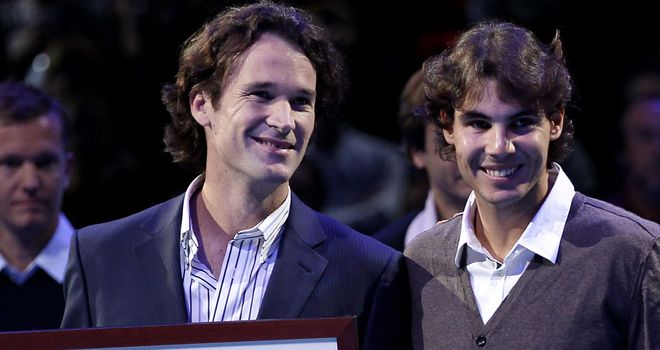 Spain's new Davis Cup skipper Carlos Moya (l) is keen to get close friend Rafael Nadal on board for the 2014 campaign which starts in January