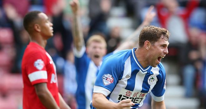 Grant Holt: Celebrates his equaliser against Blackburn