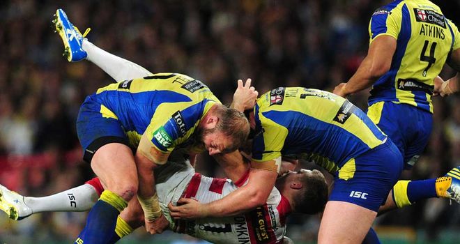 Gareth Carvell (left) tackles Wigan's Sam Tomkins during the Grand Final