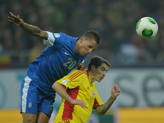 Jose Holebas wins a header.