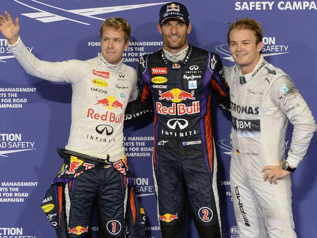 Webber poses with Vettel and Rosberg after taking pole position