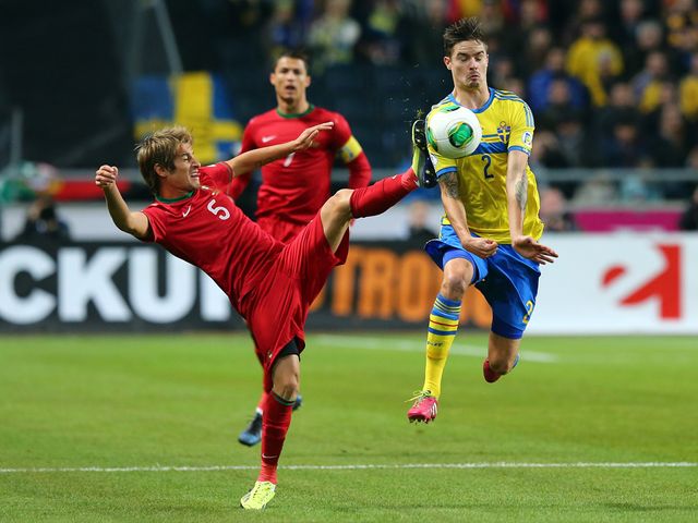 Fabio Coentrao challenges Mikael Lustig.