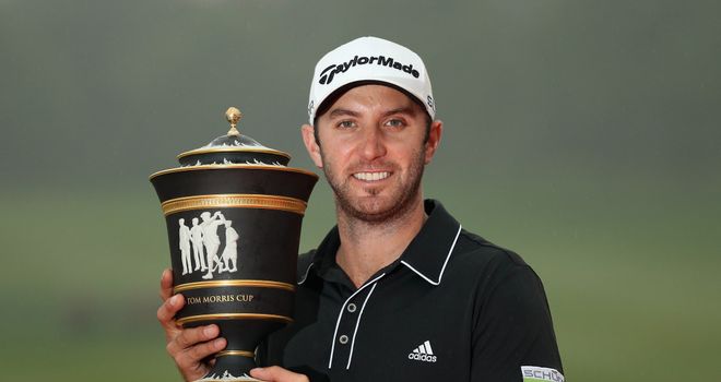 Dustin Johnson holds the trophy after his three-shot triumph