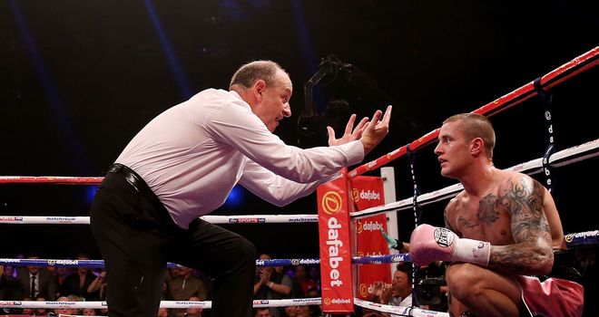 Burns receives a count after being sent to the canvas by Beltran