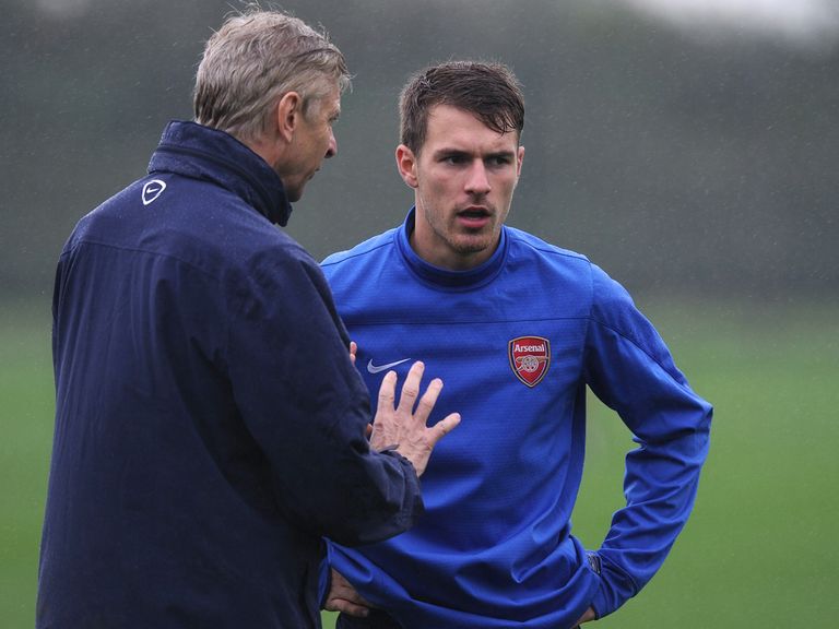 Aaron Ramsey receives instruction from Arsenal boss Arsene Wenger