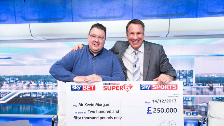 Jackpot winner Kevin Morgan is presented with his cheque for £250,000 by Soccer Saturday pundit Paul Merson.