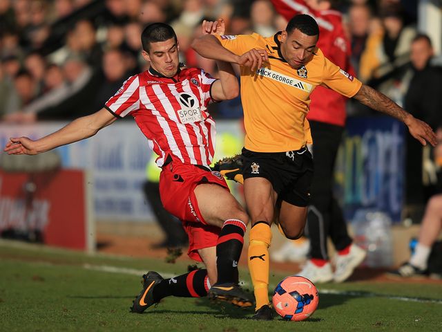 Sheffield United midfielder Conor Coady (l) tackles Cambridge's Nathan Arnold