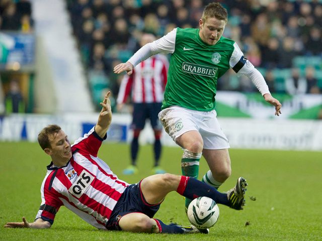Jeroen Tesselaar makes a tackle on Paul Cairney