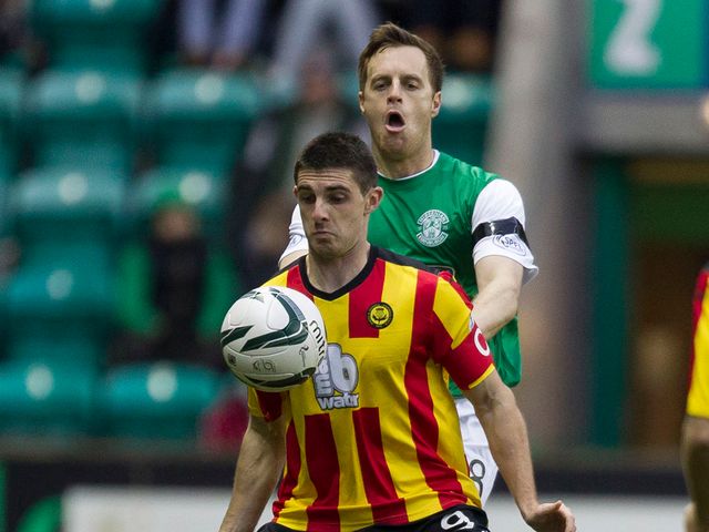 Kris Doolan holds off Hibernian's Alan Maybury