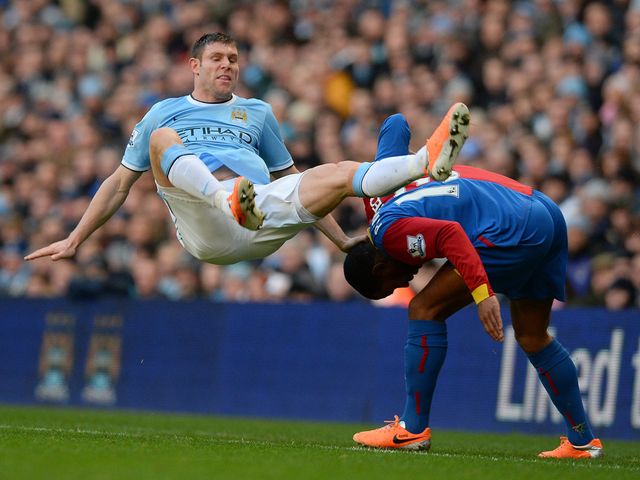James Milner falls to the ground