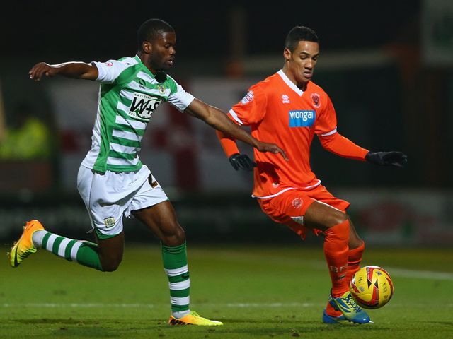 Joel Grant of Yeovil challenges Tom Ince