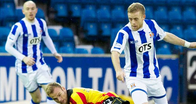 Partick's Kallum Higginbotham challenges Sammy Clingan of Kilmarnock (right)