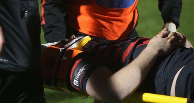 Owen Farrell is carried off the field in a neck brace