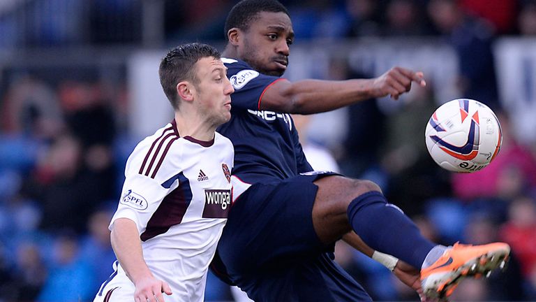 Dale Carrick of Hearts and Yann Songo'o in action at Dingwall
