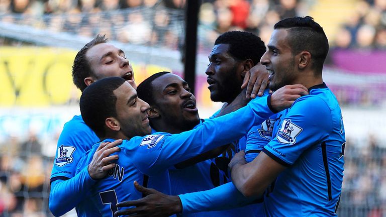 Emmanuel Adebayor: Mobbed by his team-mates after netting the opener