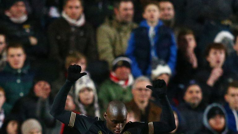 Marc-Antoine Fortune celebrates after scoring Wigan's third against MK Dons