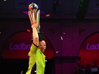 Michael van Gerwen lifts his prize.