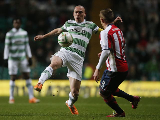 Scott Brown and Sammy Clingan battle for the ball