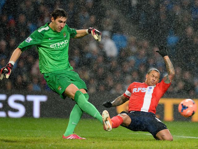 Costel Pantilimon kicks the ball away from DJ Campbell