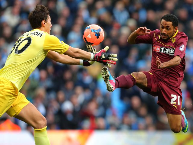 Costel Pantilimon gets to the ball ahead of Ikechi Anya