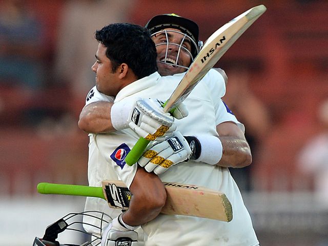 Misbah congratulates Azhar Ali on his century.