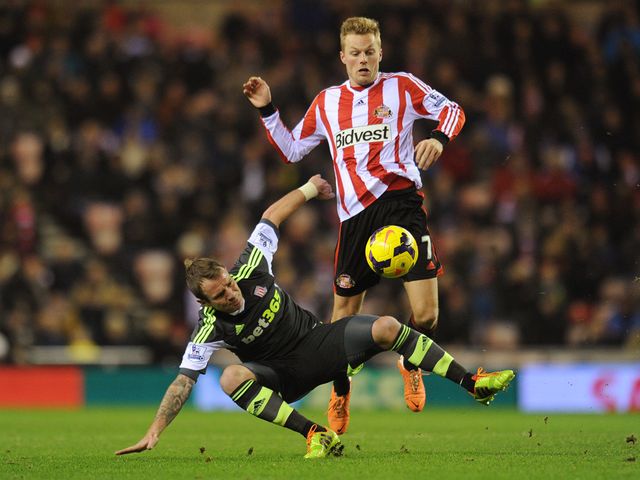 Sebastian Larrson tries to avoid a challenge from Glenn Whelan
