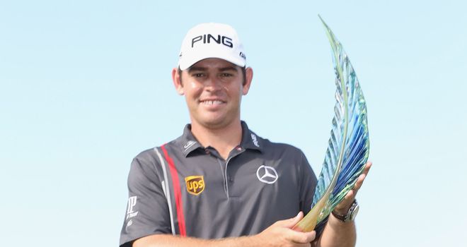 Louis Oosthuizen holds aloft the trophy