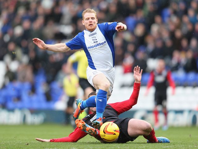 Chris Burke of Birmingham tangles with Anthony Gerrard