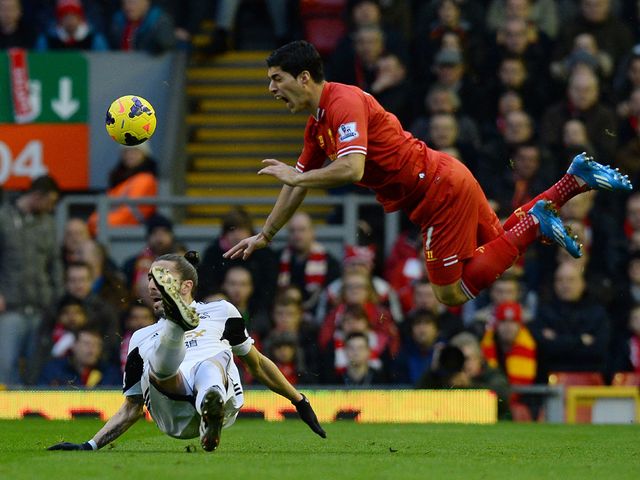 Luis Suarez takes a tumble