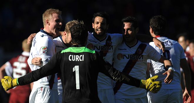 Bologna players celebrate victory at Torino