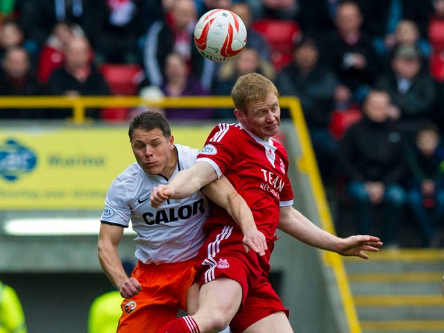 John Rankin contests an aerial ball with Barry Robson