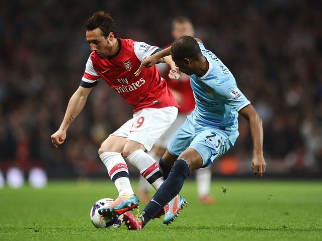Santi Cazorla and Fernandinho battle for the ball