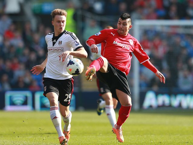 Fulham's Cauley Woodrow left and Cardiff's Gary Medel