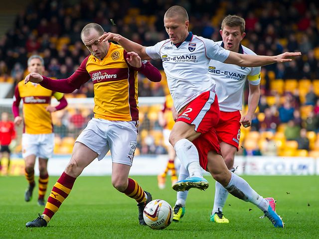 James McFadden battles it out with Erik Cikos