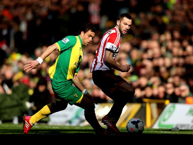 Johan Elmander keeps track of Phil Bardsley