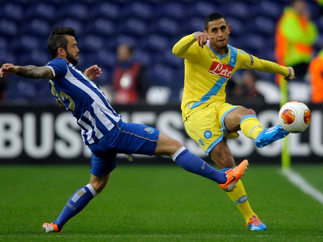 Napoli defender Faouzi Ghoulam vies with Steven Defour