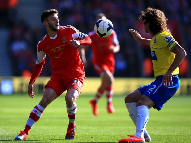 Adam Lallana and Fabrizio Coloccini battle for the ball