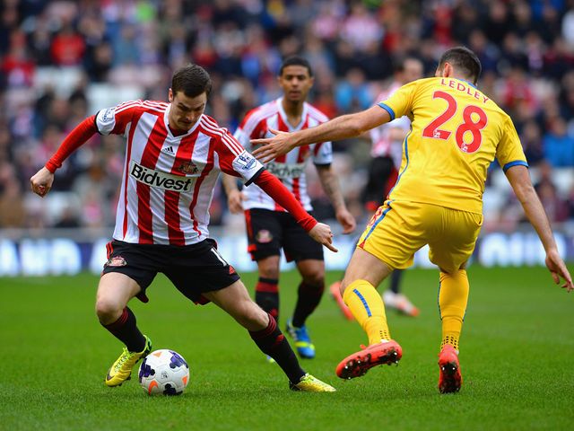 Adam Johnson tries to get past Peter Ramage
