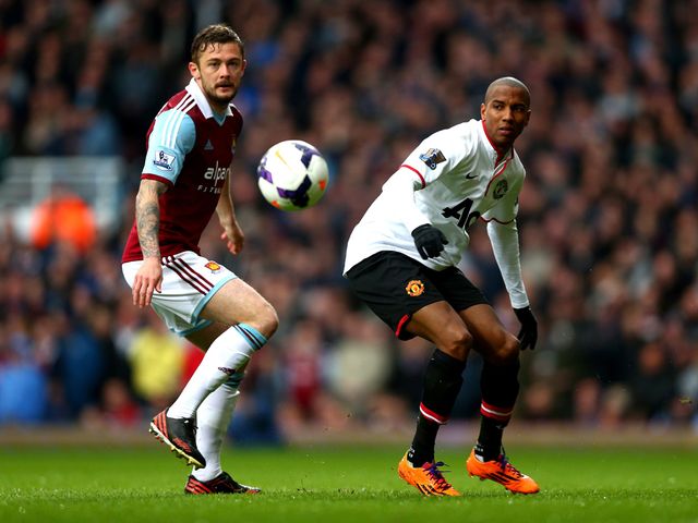 George McCartney and Ashley Young watch the ball