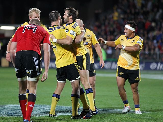 The Hurricanes celebrate against the Crusaders