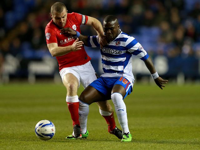 Reading's Royston Drenthe is tackled by Barnsley's Stephen Dawson