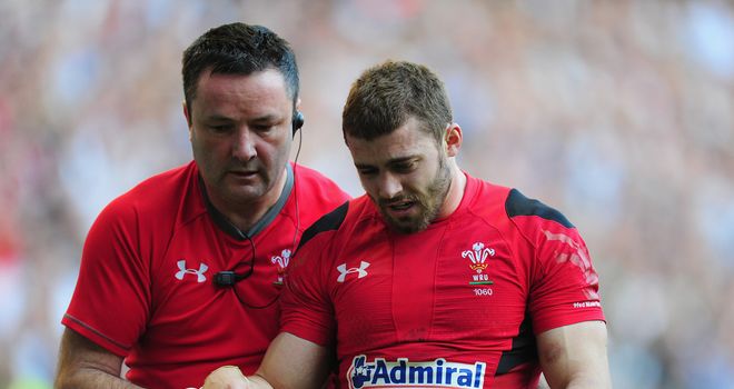Leigh Halfpenny: Wales full-back is led from the field at Twickenham
