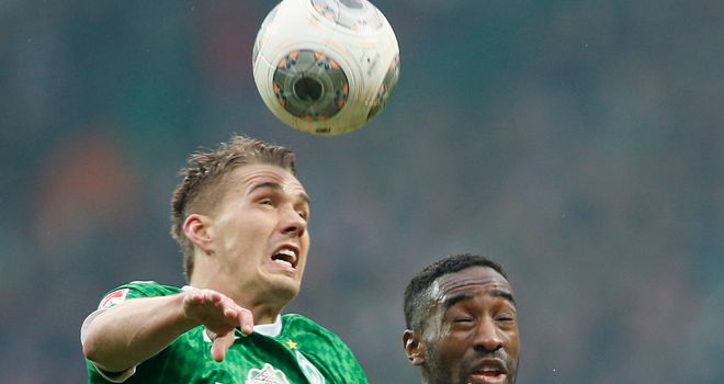 Nils Petersen and Johan Djourou battle for a high ball