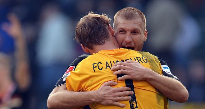 Ragnar Klavan and Alex Manninger celebrate Augburg's success