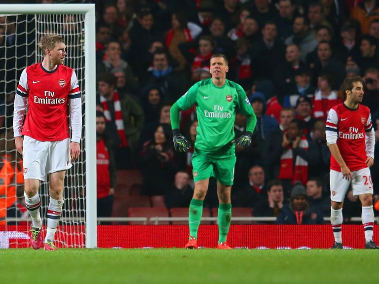 Arsenal players look dejected after the late own-goal at the Emirates Stadium